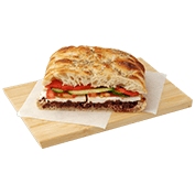 Focaccia Greca with feta cheese, olive spread, tomato, cucumber and roasted Florina pepper.