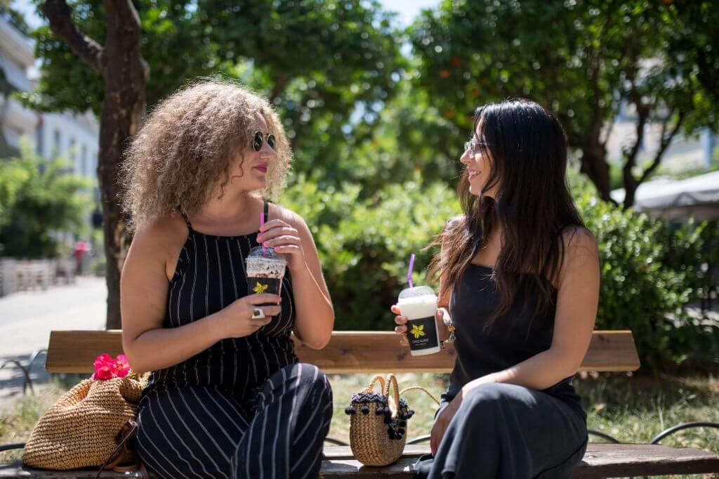 Woman smiling holding coffee
